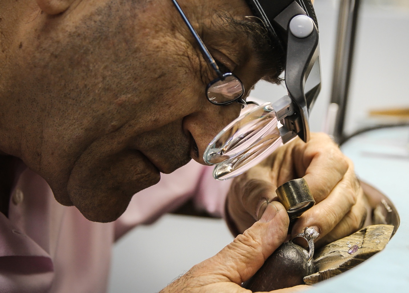 a jewelery craftsman vetting a diamond